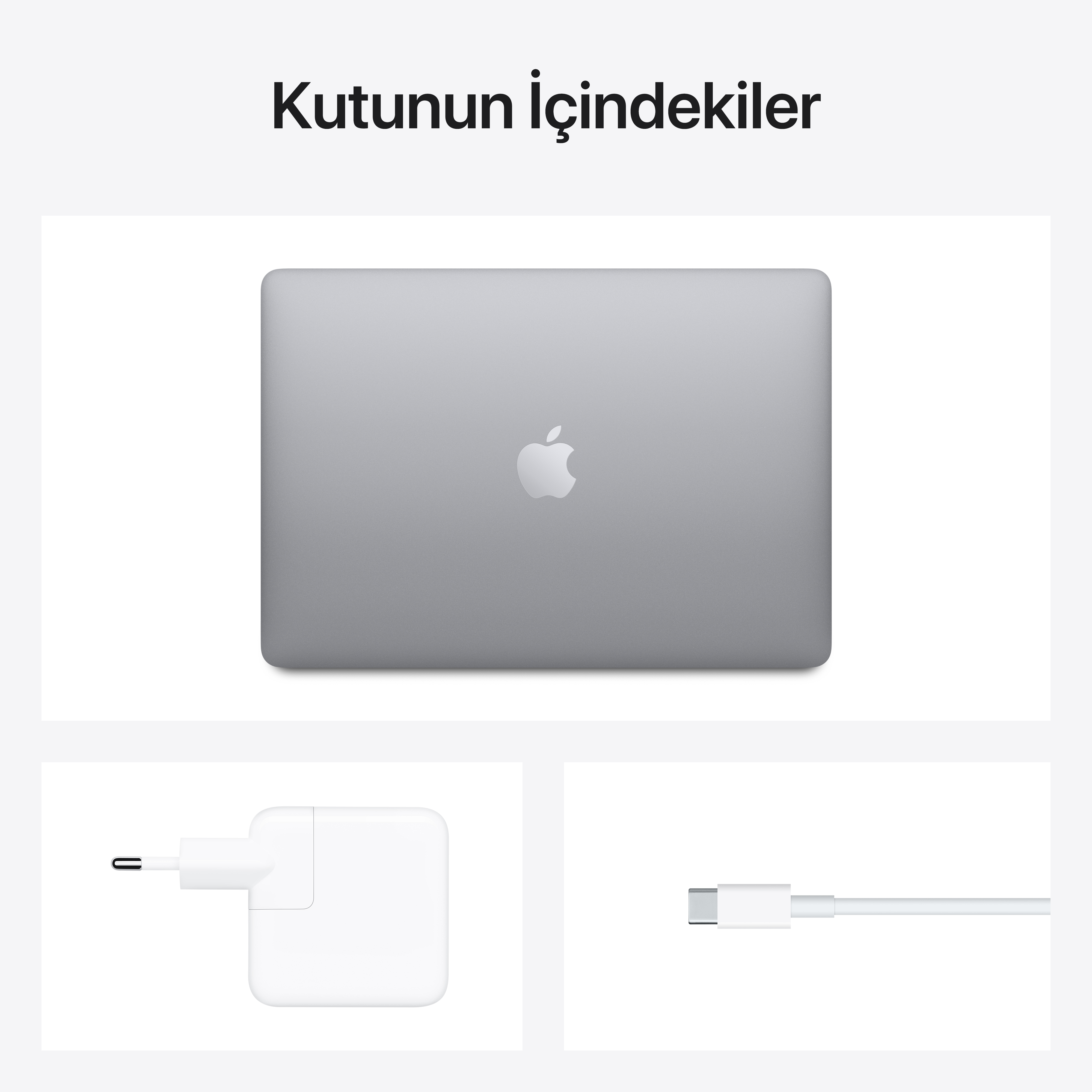 Dizüstü bilgisayar, şarj cihazı ve kablo, hepsi Apple ürünleri, beyaz arka plan.