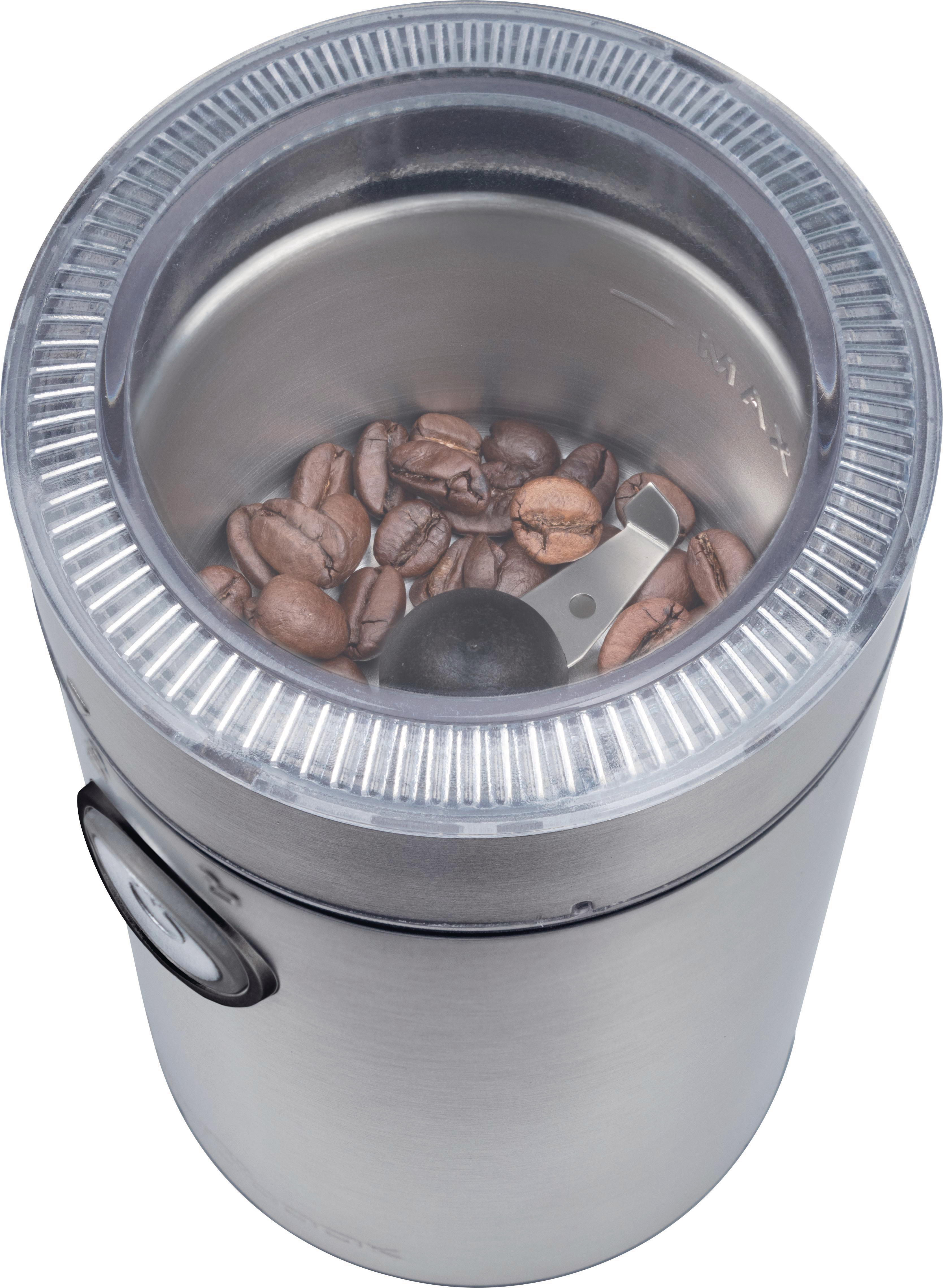 Eine Kaffeemühle mit Kaffeebohnen im Inneren und einem transparenten Deckel oben drauf.