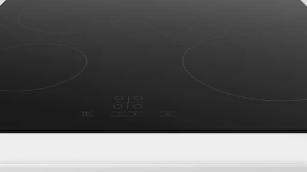 A black cooktop on a white surface. Four circular burners and control buttons are visible.