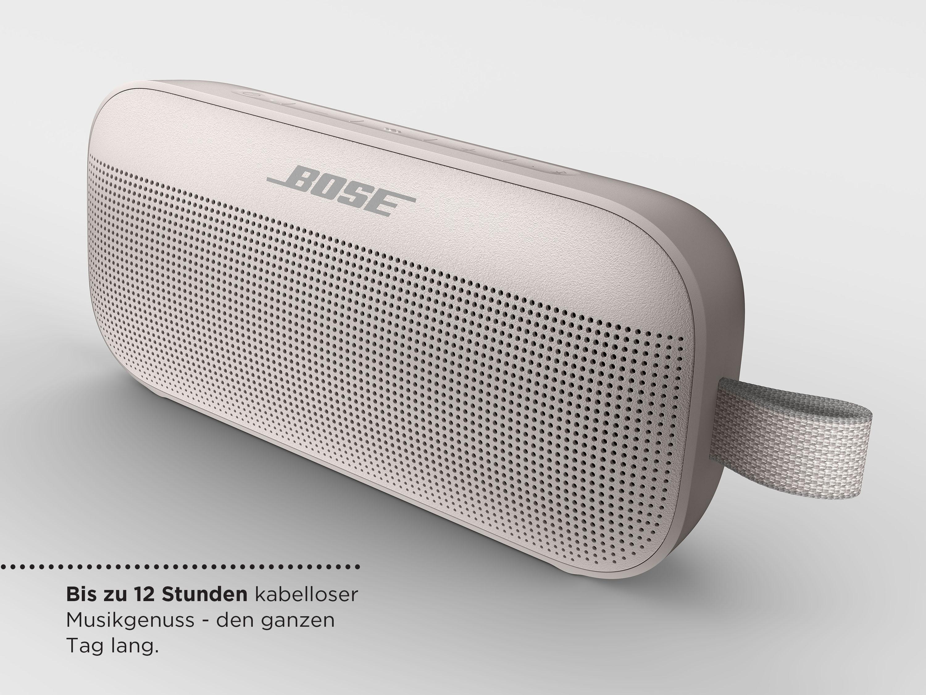 Beige Bose-Lautsprecher mit Griff auf hellgrauer Fläche.