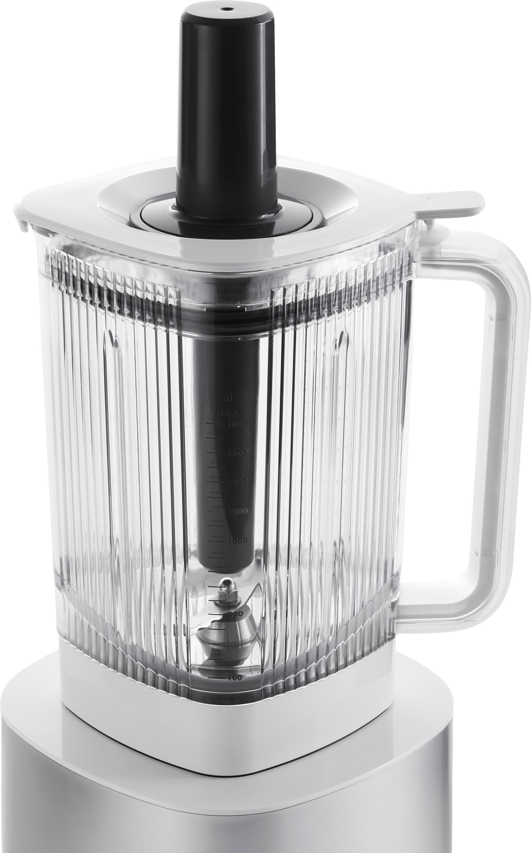 Ein Mixer steht auf einem weißen Sockel, mit einem transparenten Behälter und einem schwarzen Deckel.