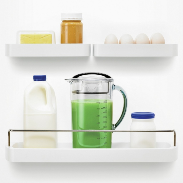 Kitchen shelves with food. Milk, juice, eggs, and butter are on the white shelves.