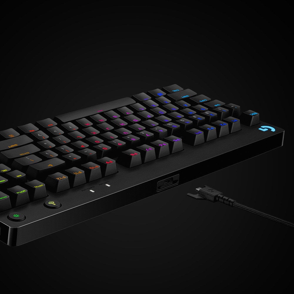 A black keyboard with illuminated keys, with a cable attached.