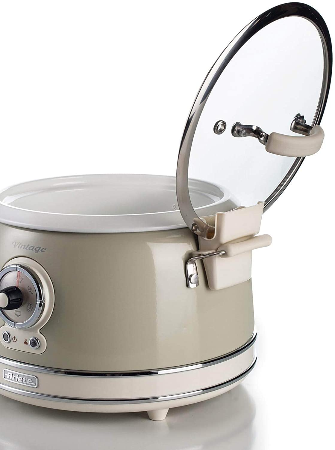 Une mijoteuse vintage crème avec un couvercle transparent ouvert.