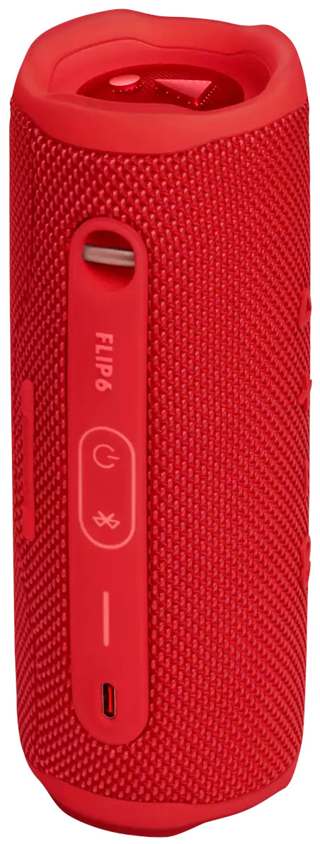 Haut-parleur JBL Flip 6 rouge, vue latérale. Ports d'alimentation, Bluetooth et charge visibles.