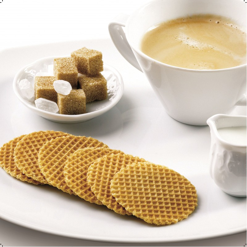Waffles, sugar cubes, coffee, and milk on a white plate.