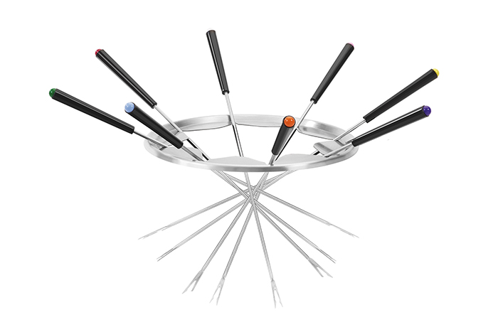 Fondue forks, with colored tips, arranged around a metal stand.