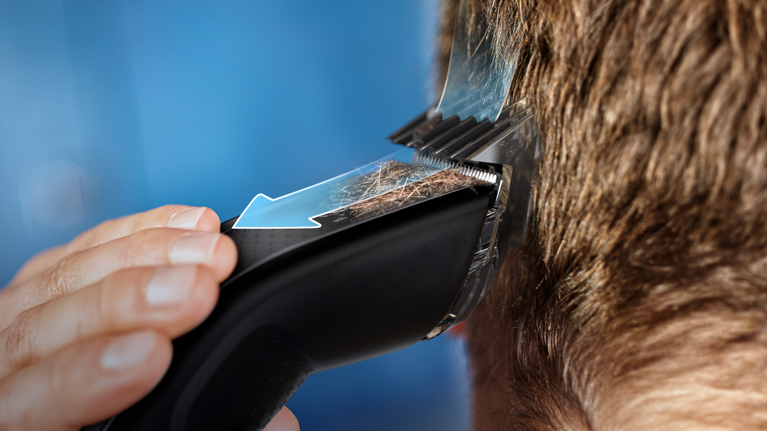 Hair being cut with a trimmer. Blue arrow indicating the cutting process.