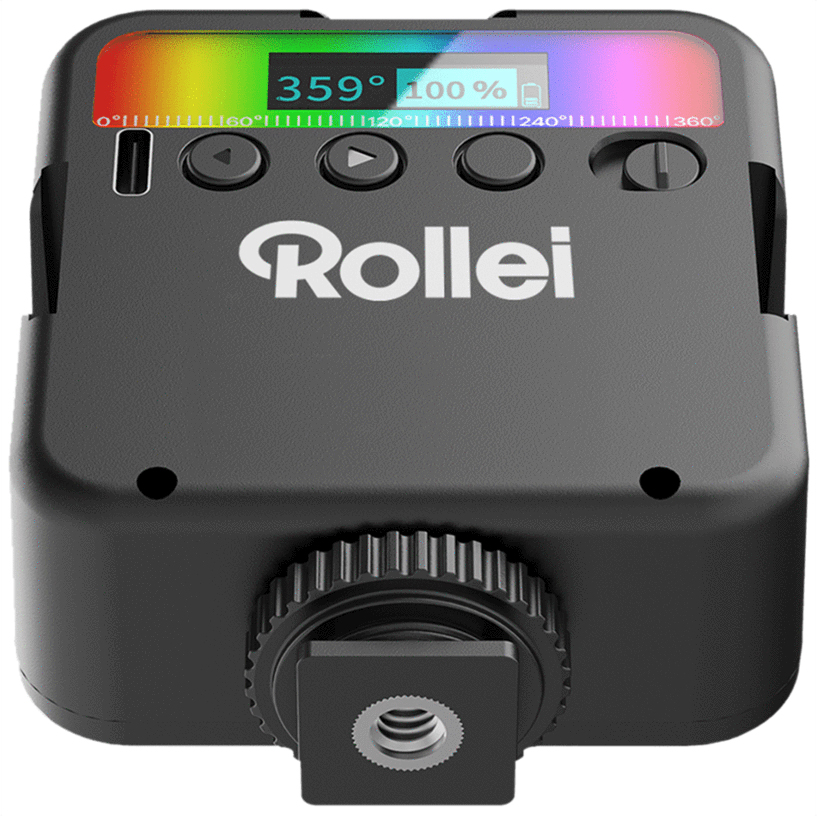 Une lumière LED noire Rollei avec un écran affichant les réglages. Elle possède des boutons et une molette. Le bord supérieur affiche un dégradé arc-en-ciel.