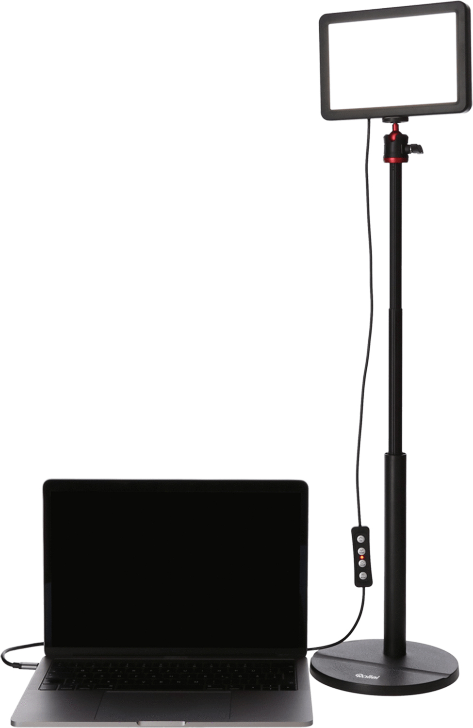 Une lampe vidéo et un ordinateur portable. La lumière sur pied et l'ordinateur sur une table, blancs.