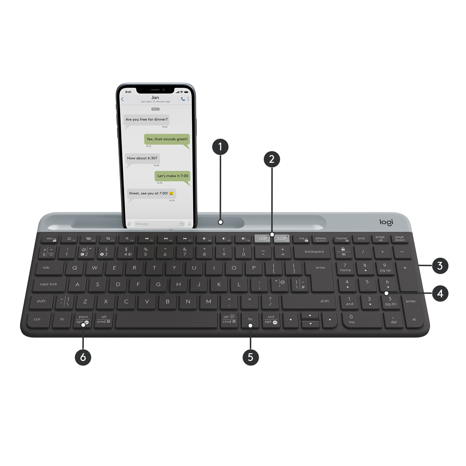 Tepside telefon bulunan siyah klavye. Telefon, bir metin mesajı konuşması görüntüler.