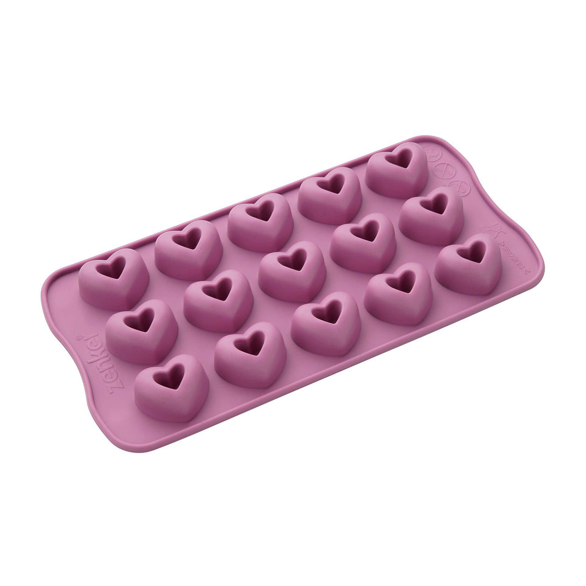 Eine pinke herzförmige Silikonform, gefüllt mit herzförmigen Formen.