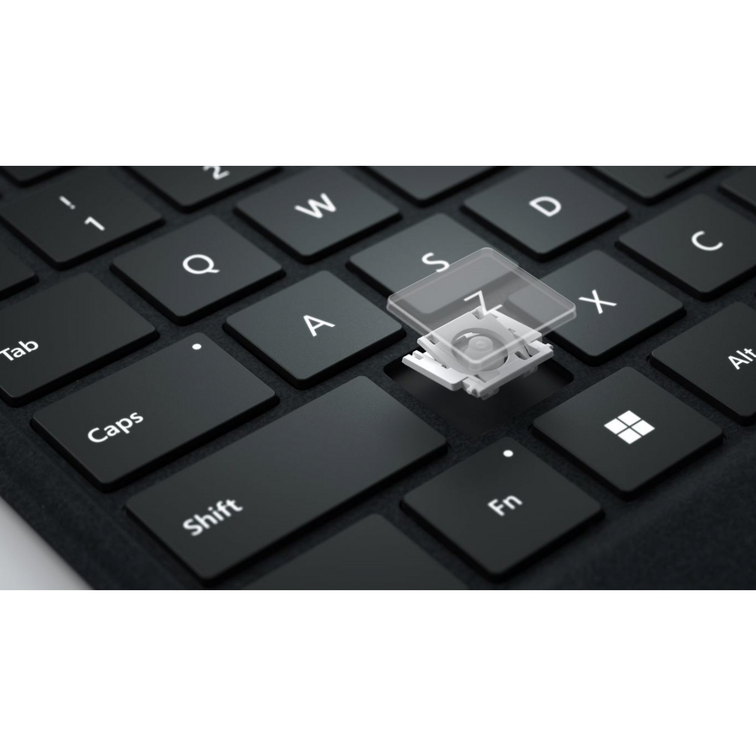 Primer plano de un teclado con una tecla extraída, que muestra el mecanismo interno debajo de la tecla.