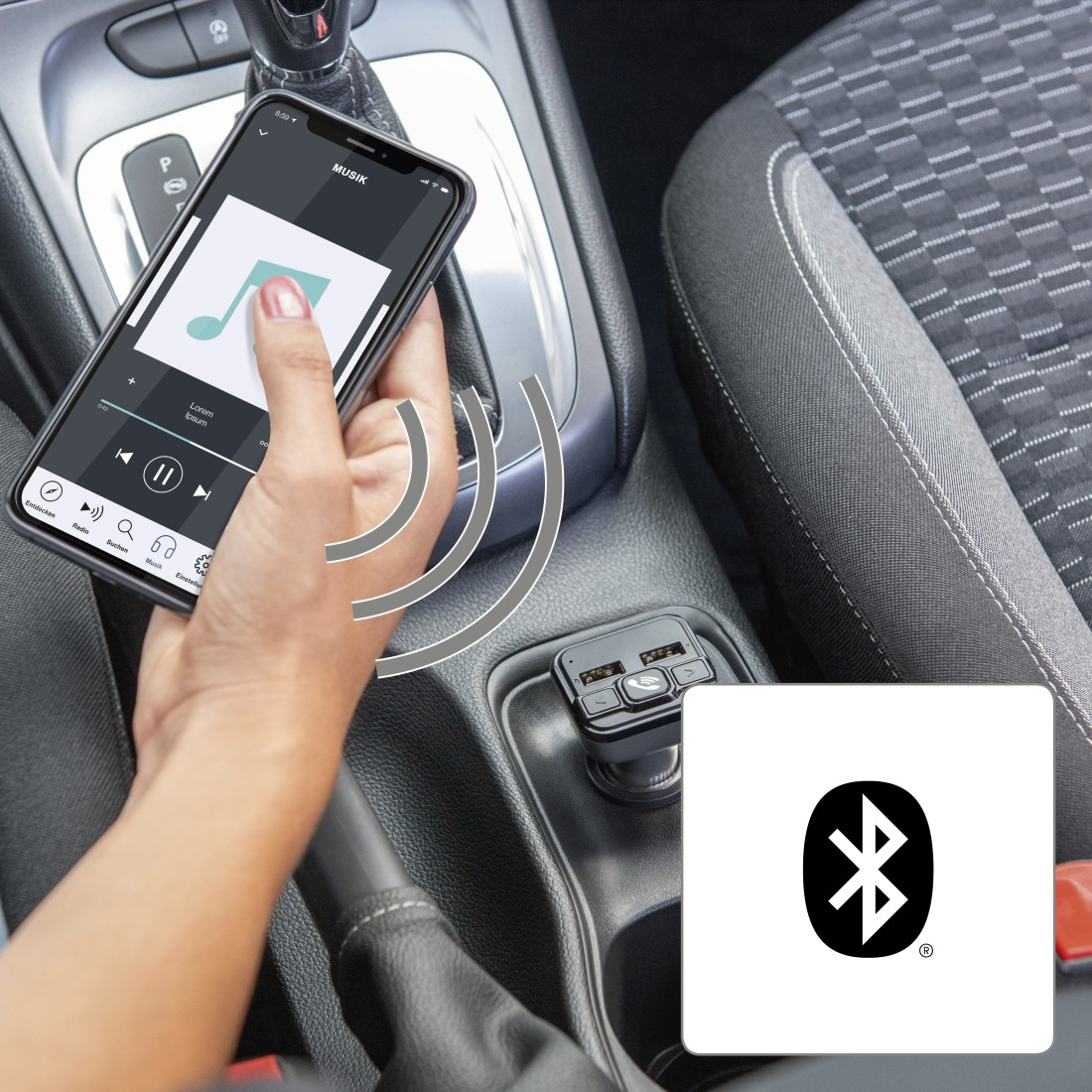 A person's hand holding a phone displaying music, with a car's interior in the background.