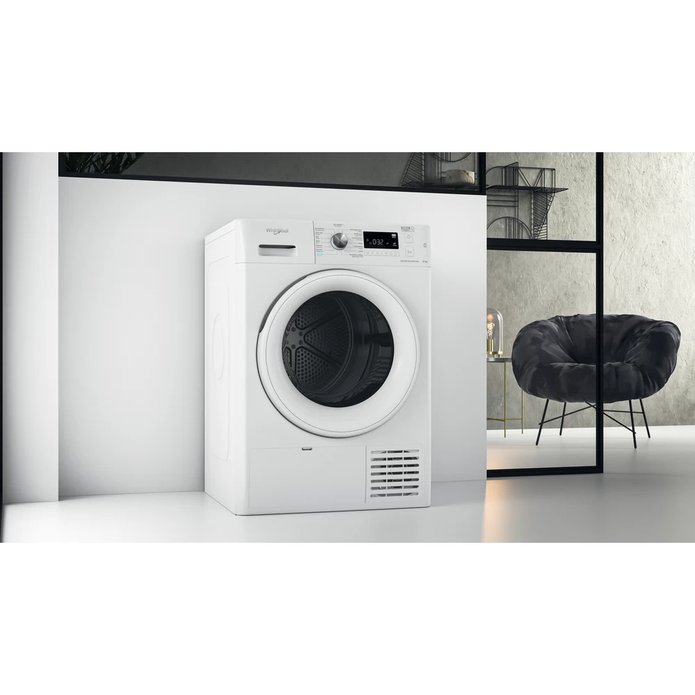 Witte Whirlpool droger op een witte muur. Een zwarte stoel op de achtergrond.