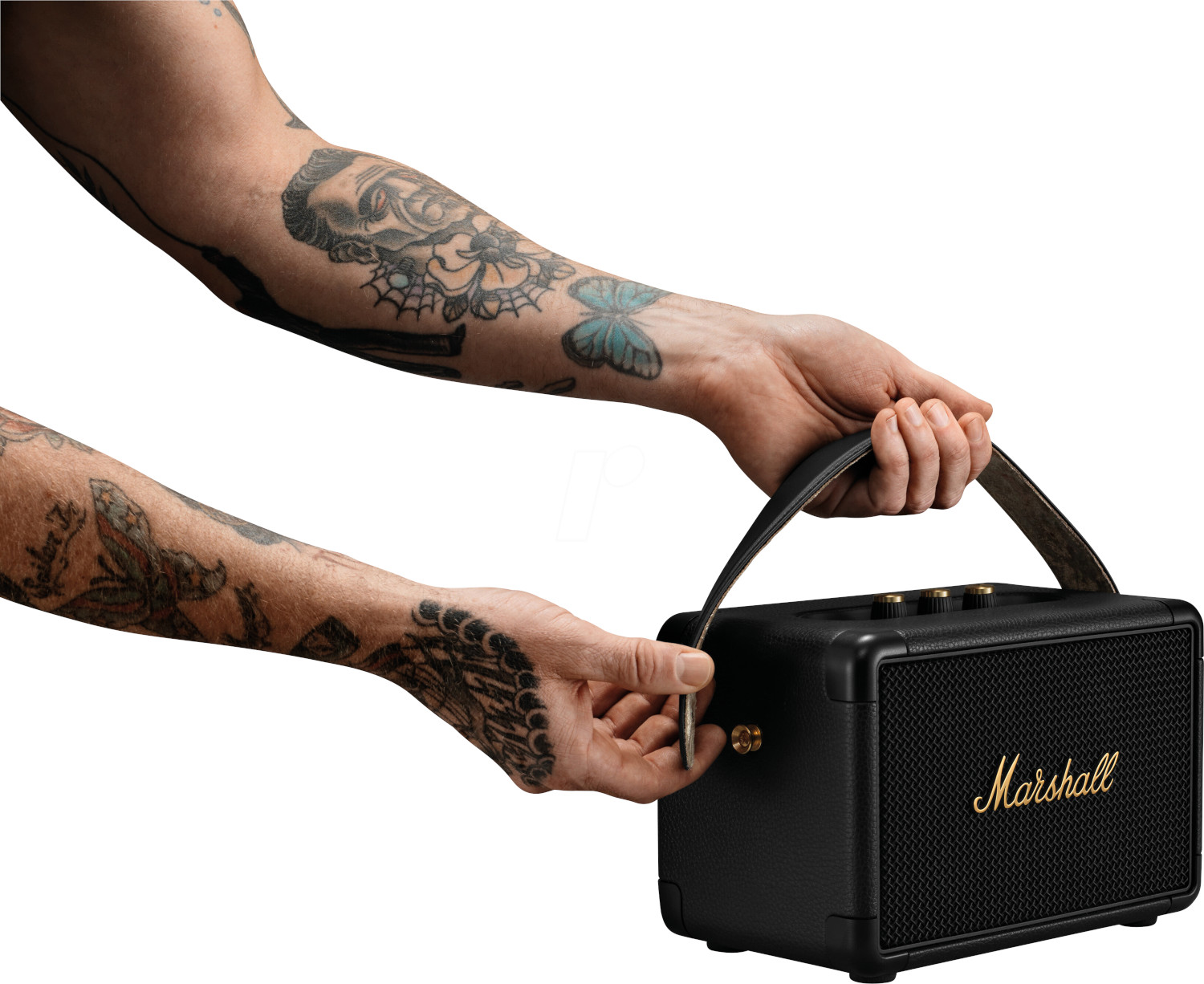 Person holding a black Marshall speaker with a leather handle.