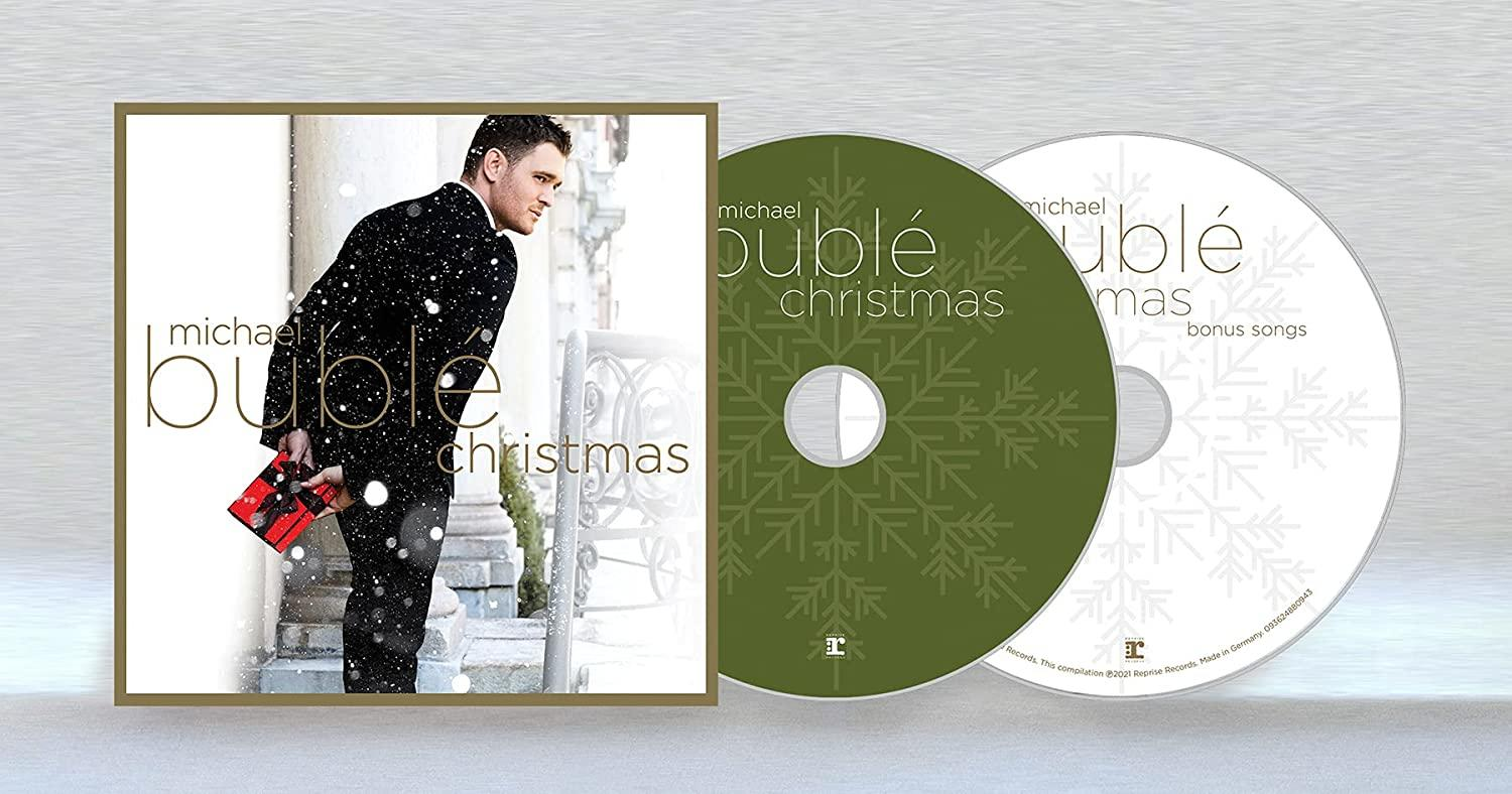 Eine CD-Hülle mit einem Mann im Anzug und Schnee. Zwei grüne CDs daneben.