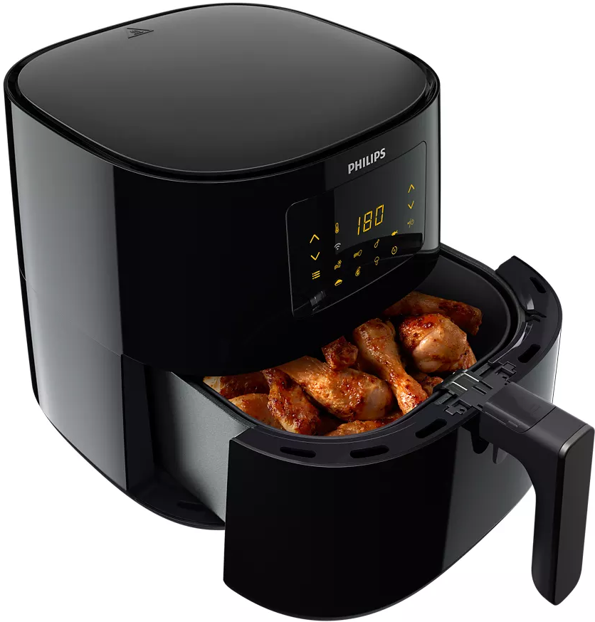 Une friteuse à air noire avec le tiroir ouvert, rempli de pilons de poulet cuits. L'écran affiche 180 degrés.