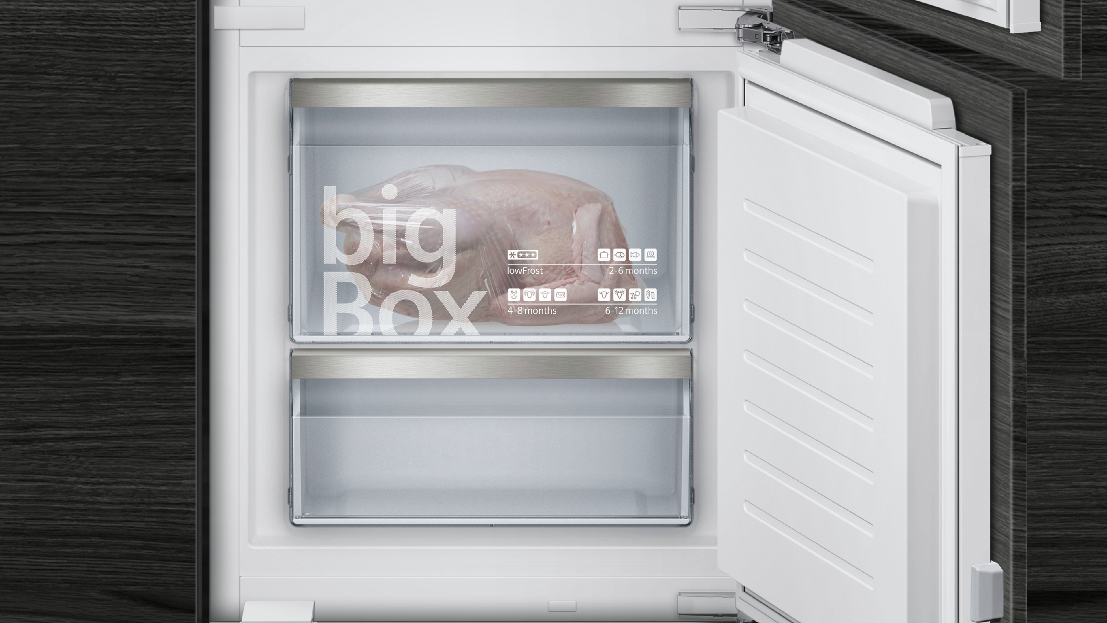 Open fridge with a whole chicken inside. The fridge door is white, and the interior has a big box freezer.
