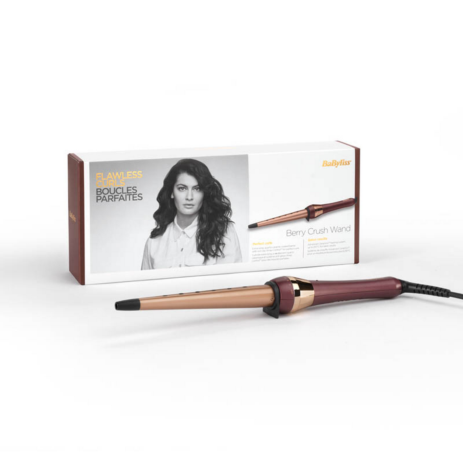 Caja y rizador de pelo. La caja muestra a una mujer con rizos perfectos. Rizador en exhibición.