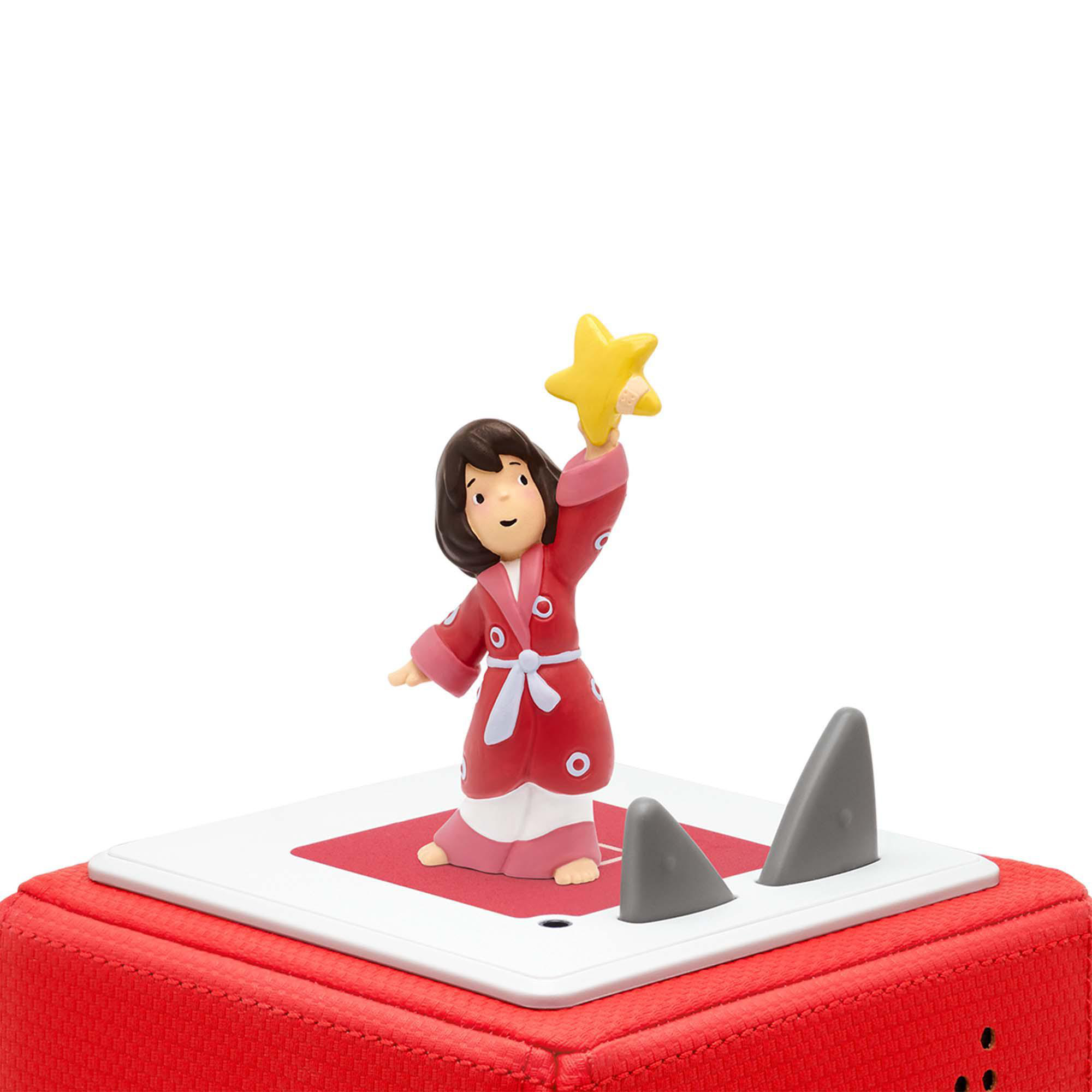 Spielfigur eines Mädchens, das einen Stern hält. Rote Kleidung, auf roter Plattform mit Haifischflossen.