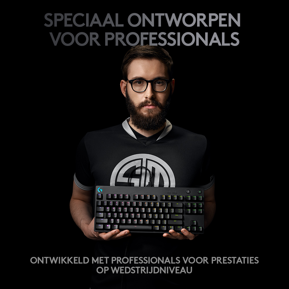 Man holding a keyboard, the background is black.