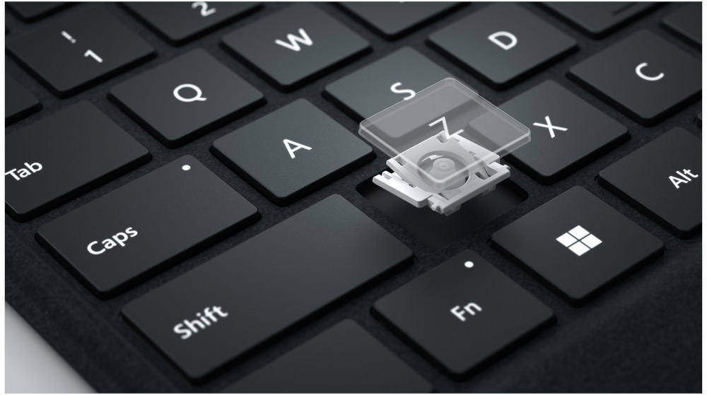 Close-up of a keyboard with a key removed, showing the internal mechanism.