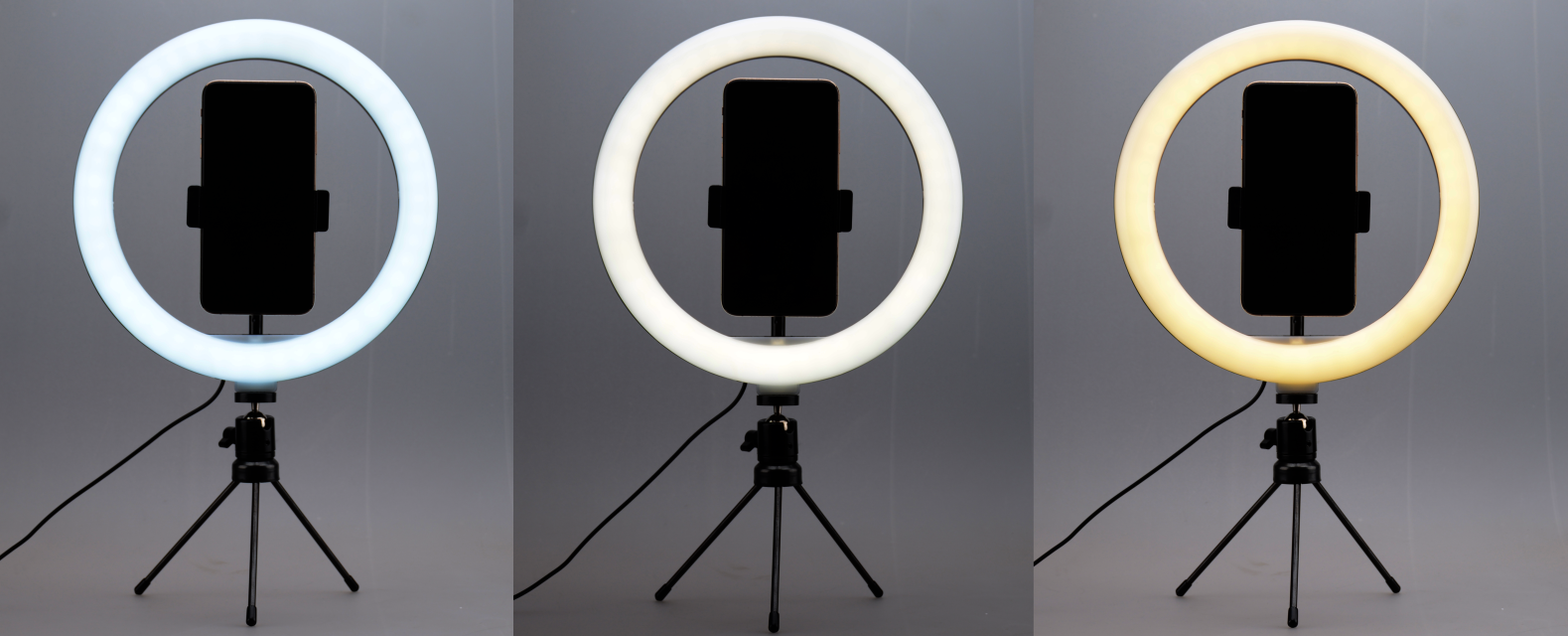 Three ring lights with varying light colors mounted on tripods.