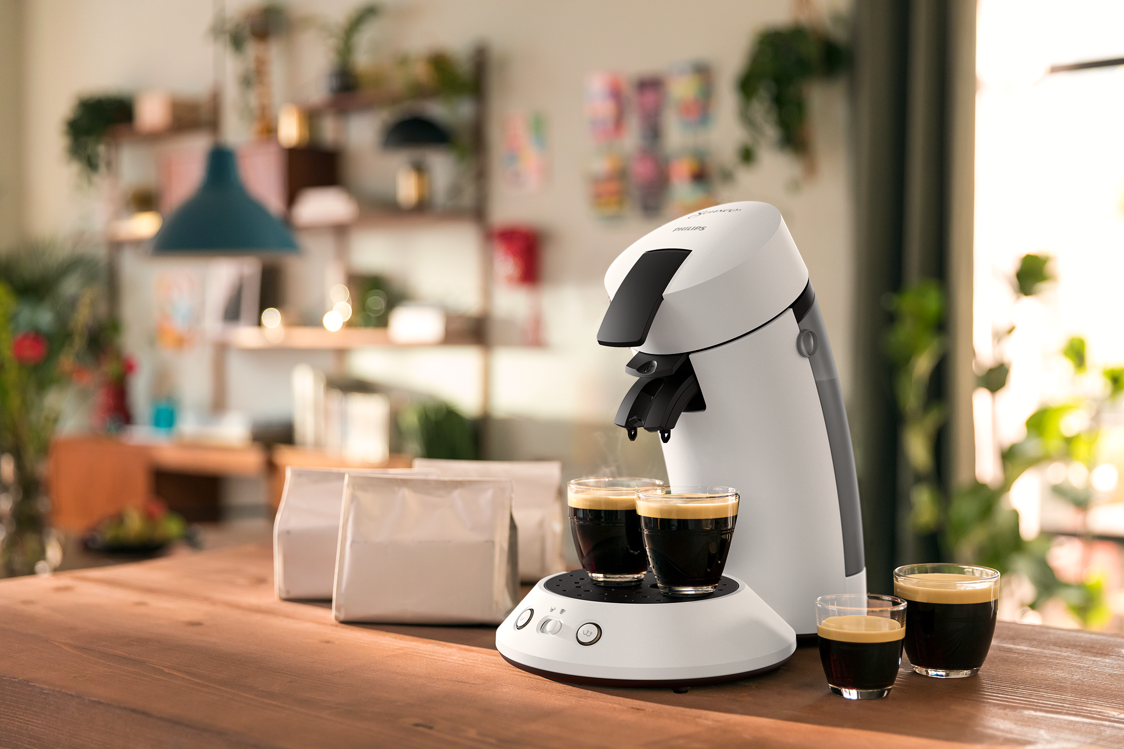 Philips Senseo coffee machine with two cups of coffee on the table.