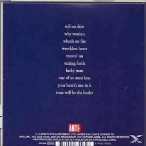 A dark blue CD back cover with white text listing song titles and copyright information.