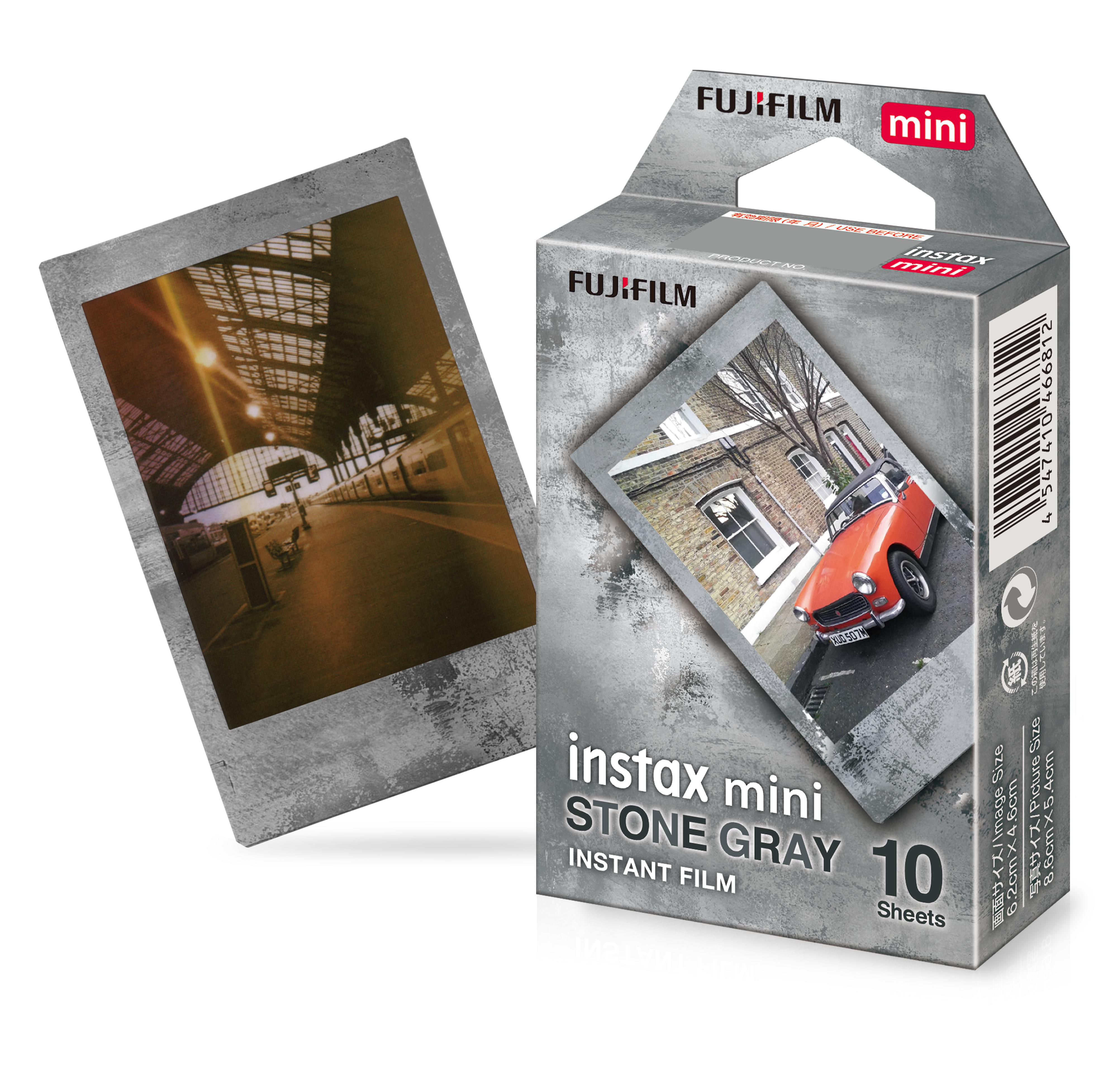 Eine Filmbox mit zwei Instax Mini-Fotos. Ein Foto ist ein Bahnhof, das andere ein Auto.