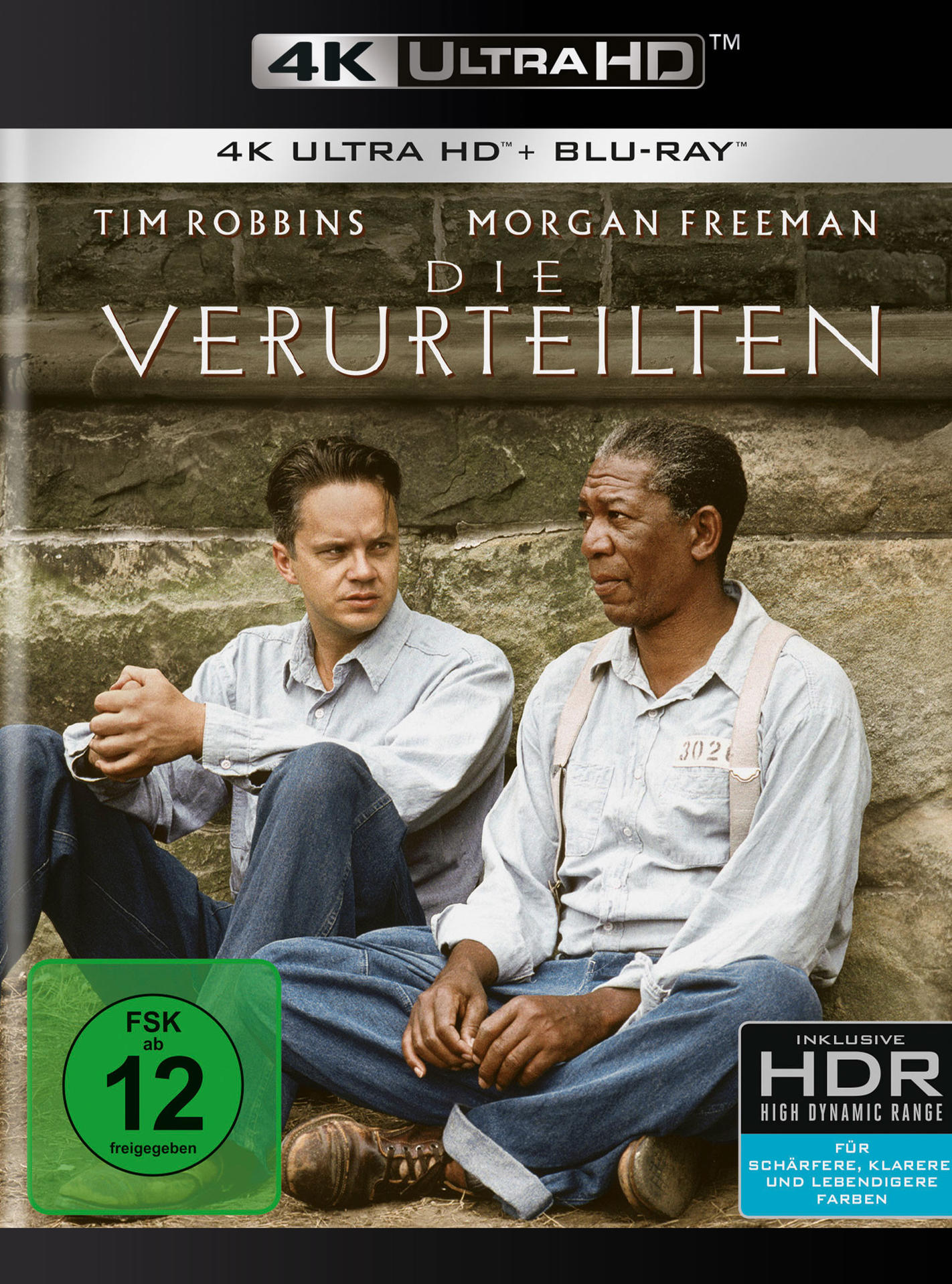 DVD-Cover mit Tim Robbins und Morgan Freeman. Dunkle Farben und Text. Weißer Hintergrund.