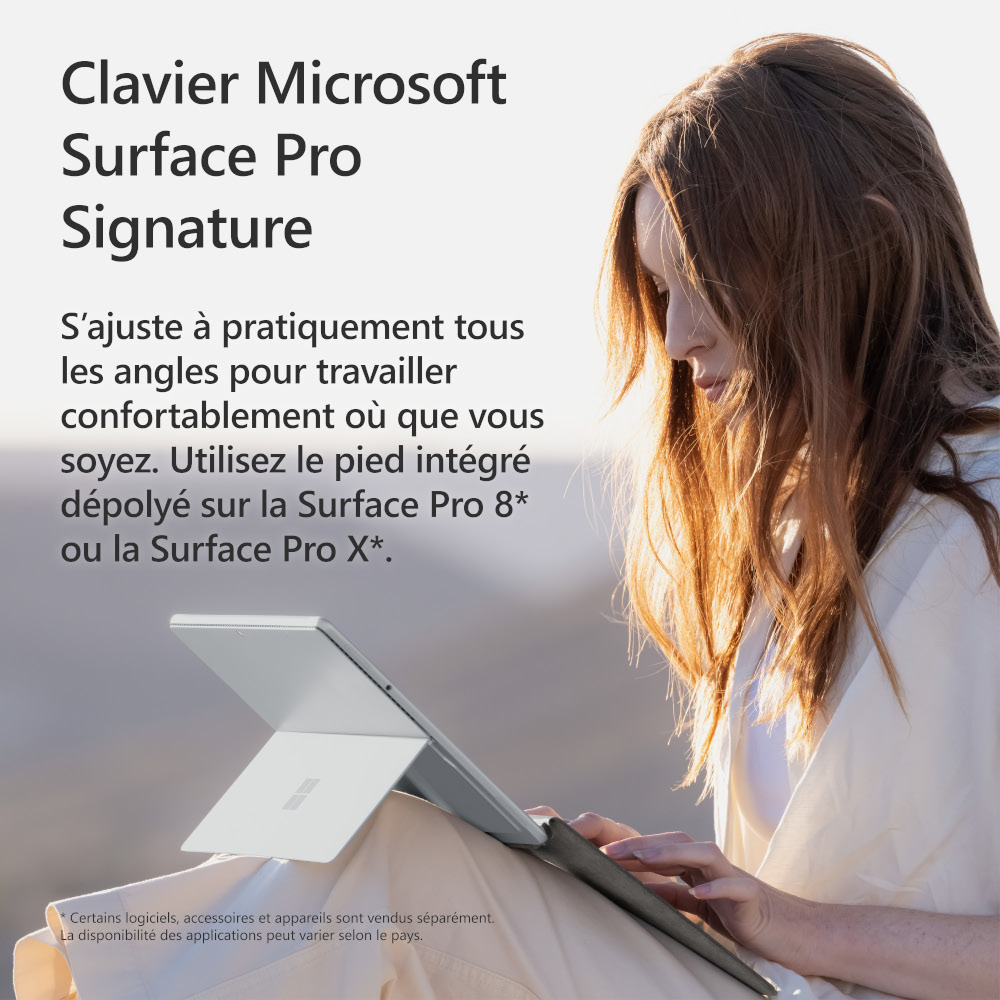 A woman using a silver Microsoft Surface Pro Signature keyboard.