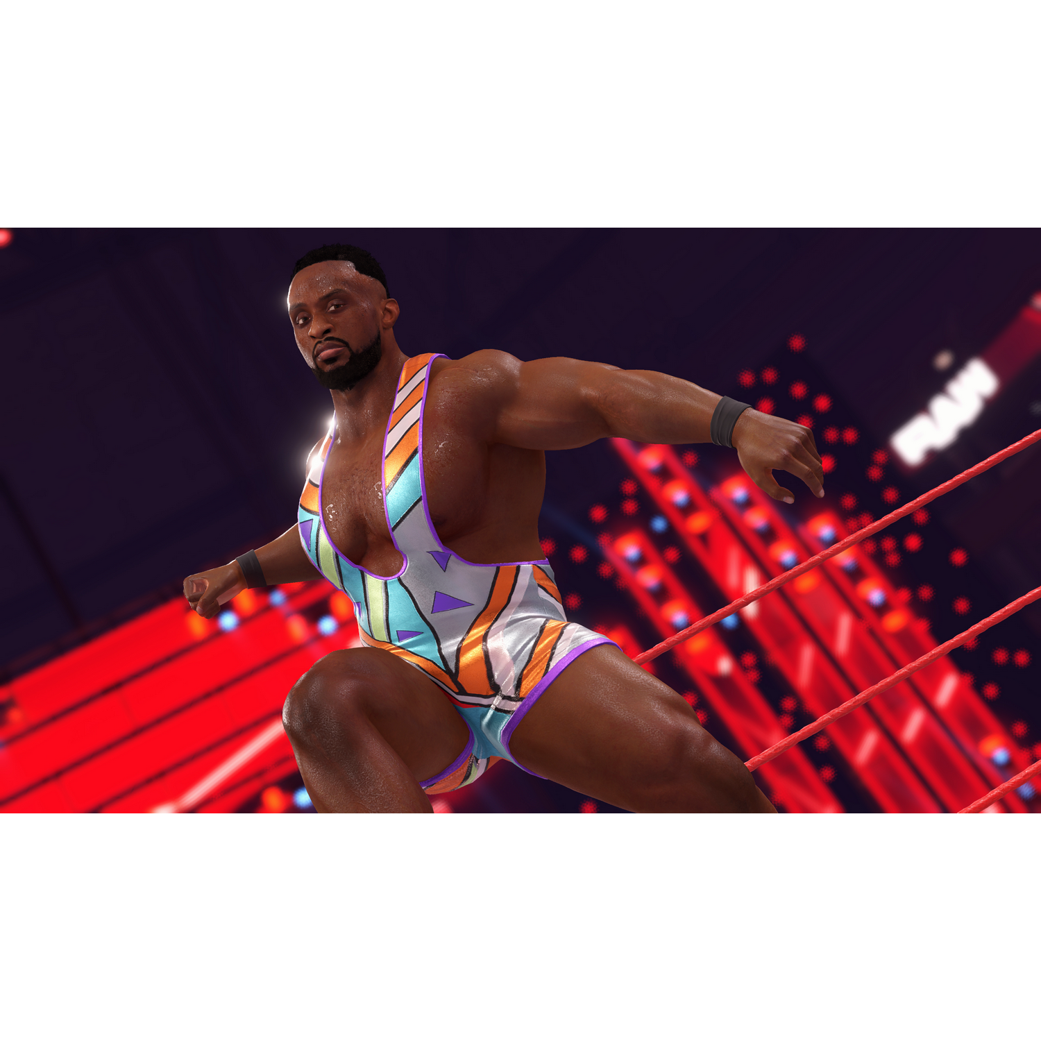 Un luchador con un atuendo colorido se encuentra en un ring de lucha libre, posando para la cámara.