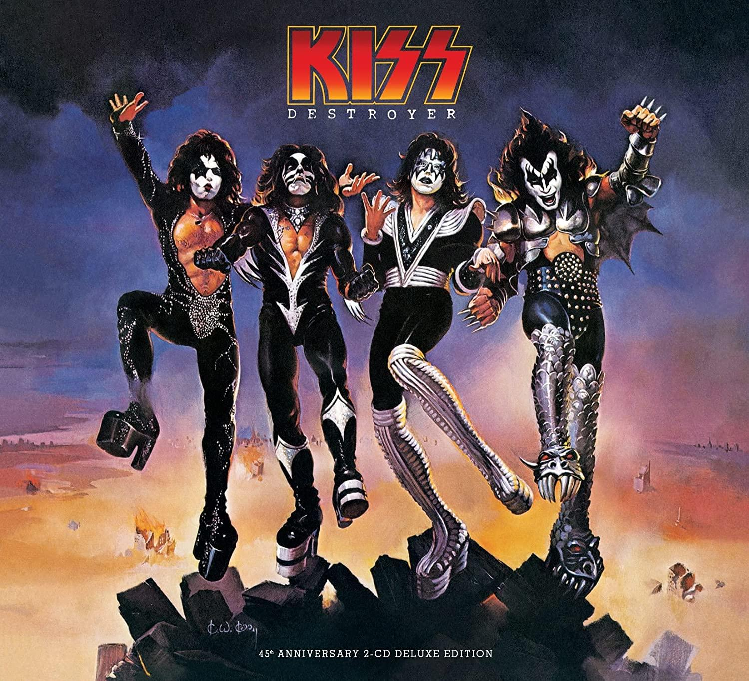 Albumcover: Kiss-Bandmitglieder in Make-up und Kostümen, die auf einer felsigen Oberfläche stehen.