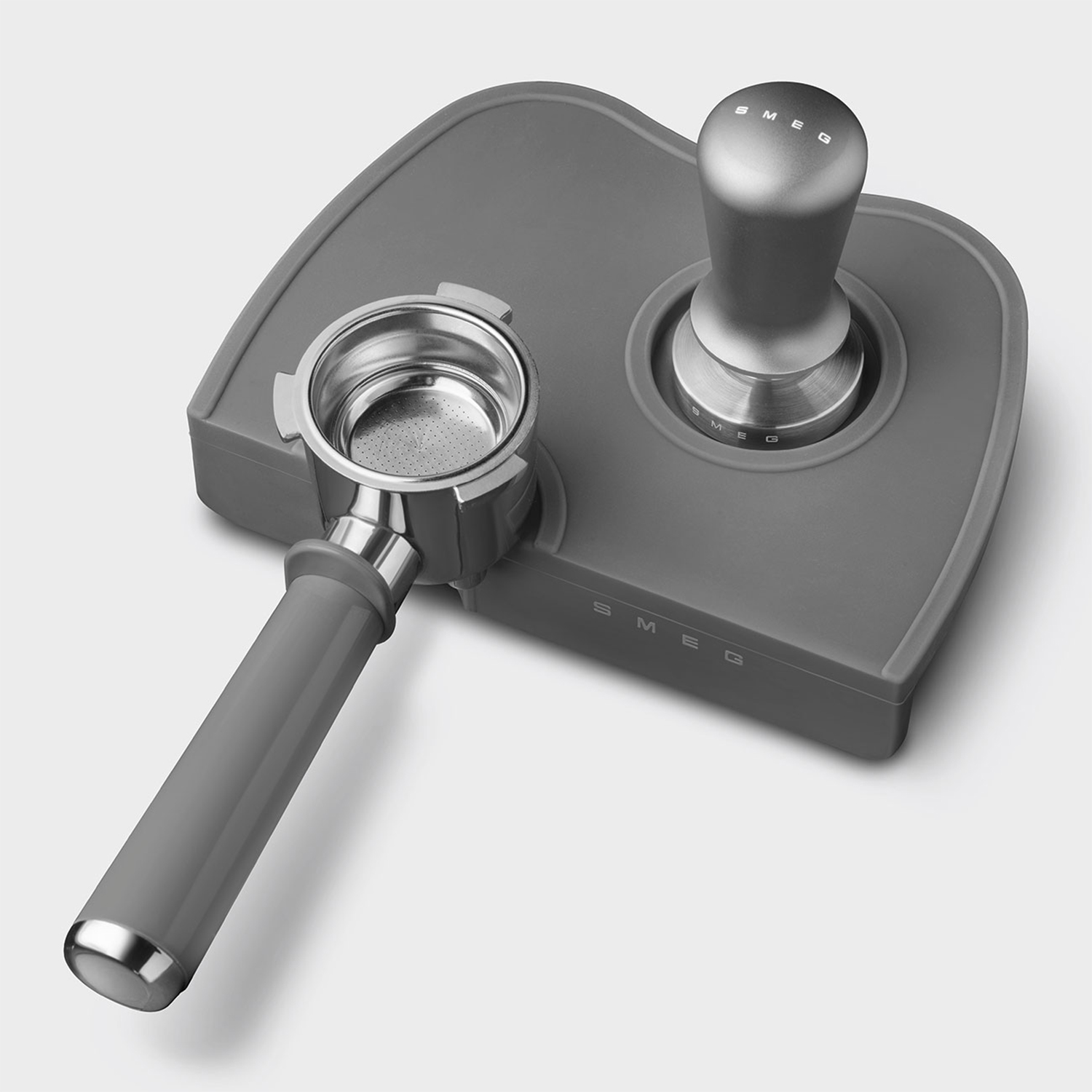 Un set di accessori per macchina da caffè grigio, tra cui un portafiltro e un tamper.
