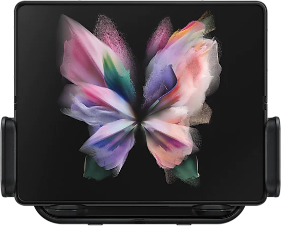 Une tablette pliable dans un support, affichant une image colorée en forme de papillon sur l'écran.