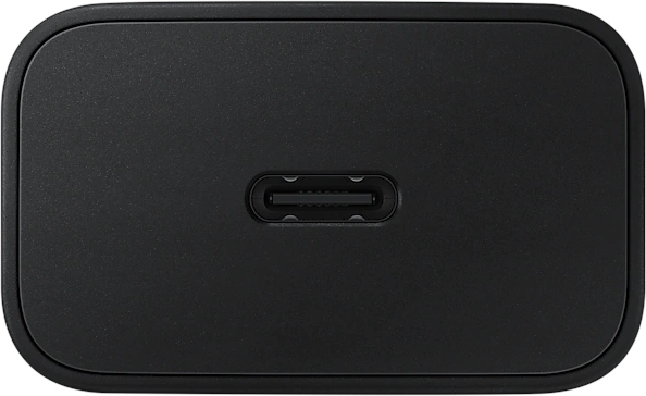 A black charger with a USB-C port is shown. It is rectangular with rounded corners.