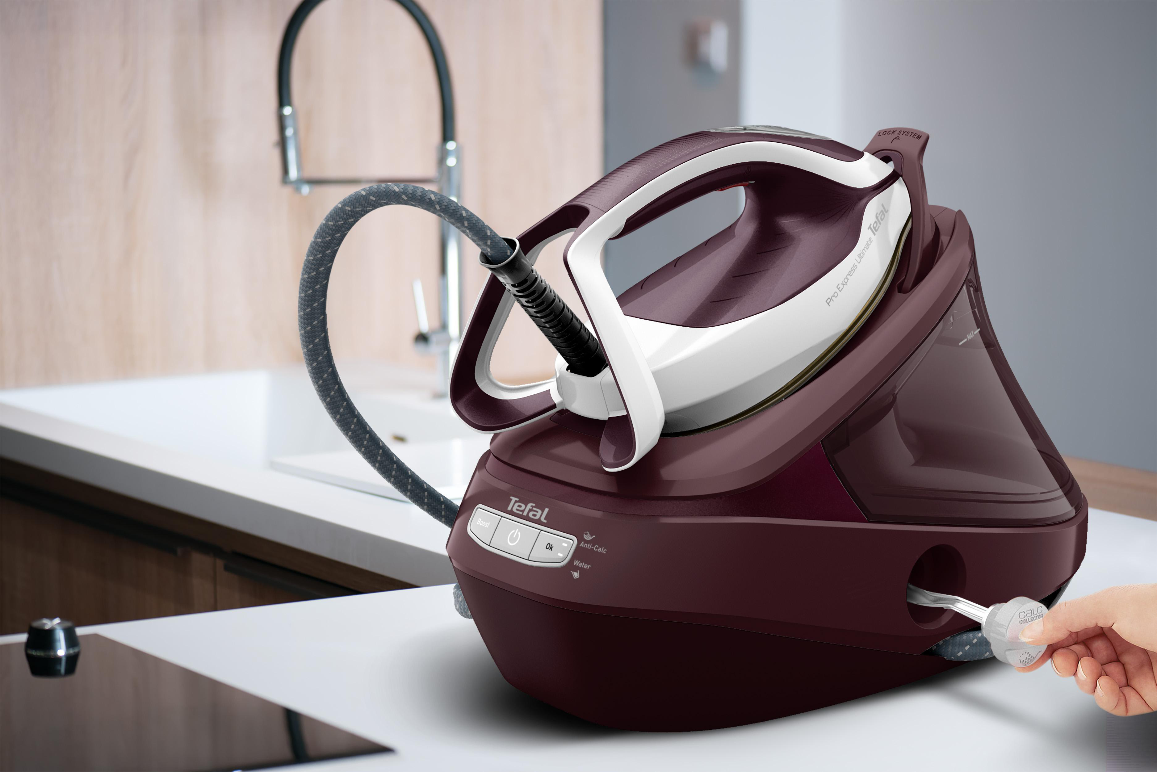 Burgunderrotes und weißes Tefal-Bügeleisen. Dampfschlauch verbindet sich mit einer Basis.