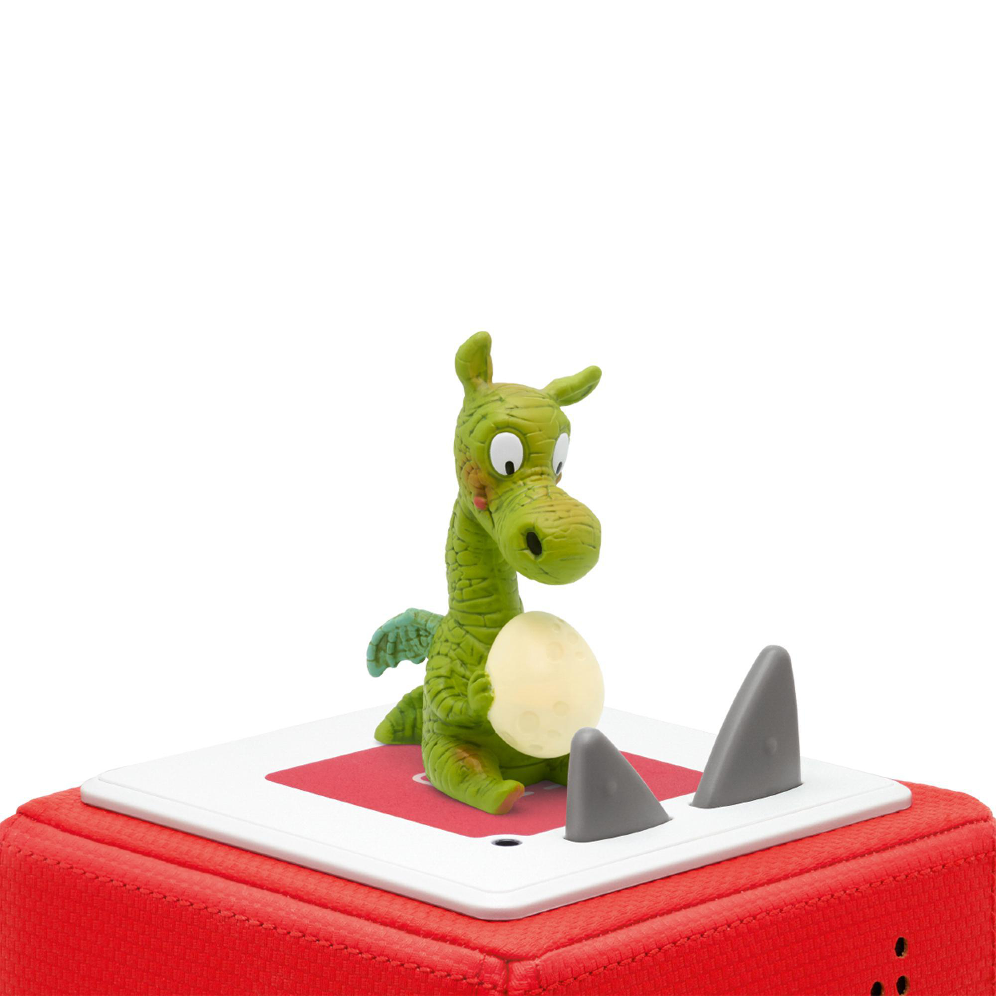 Grüner Spielzeugdrache, der ein leuchtendes Ei auf einer rot-weißen Basis mit grauen Haifischflossen hält.