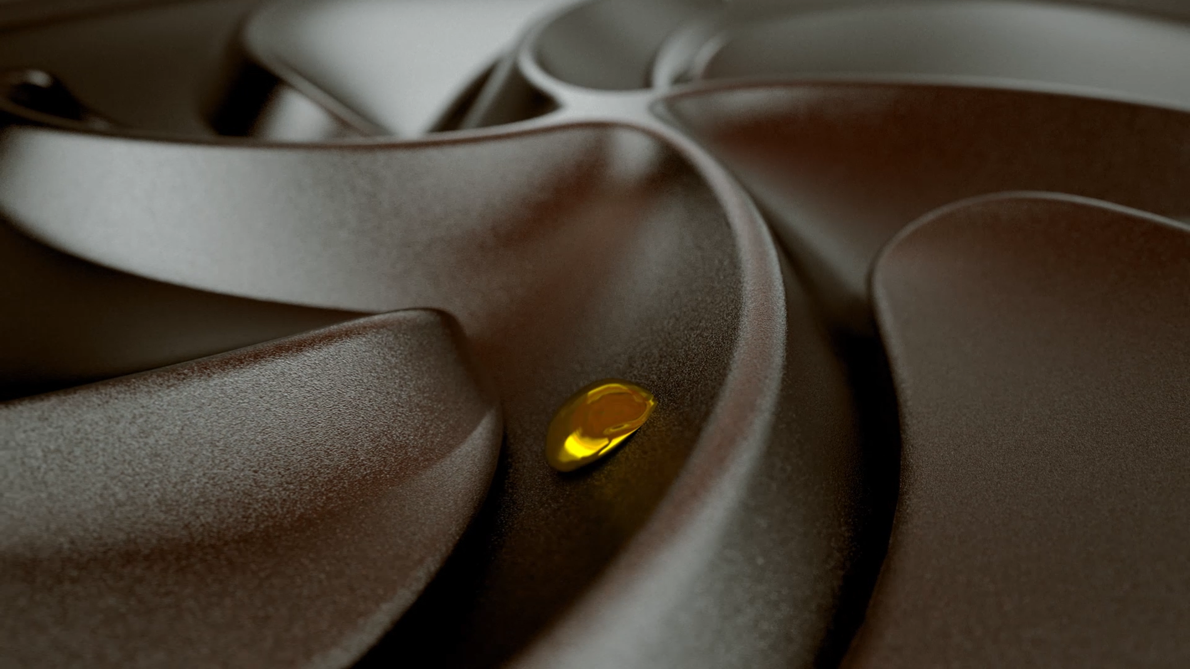 A close-up of a dark surface with a small, golden drop of liquid in the center.