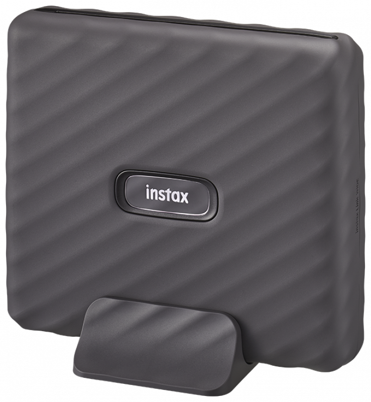 Dark gray Instax Link printer with a stand. 'Instax' logo on front.