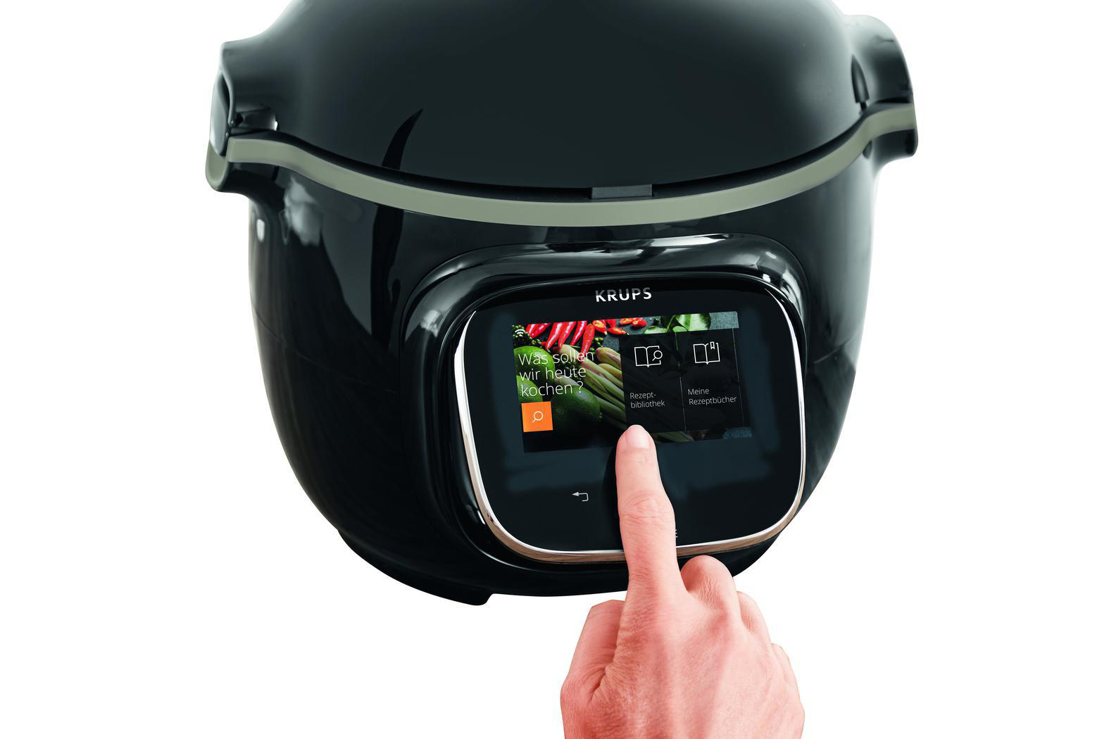 Eine Hand berührt einen Touchscreen auf einem schwarzen Krups Multikocher.