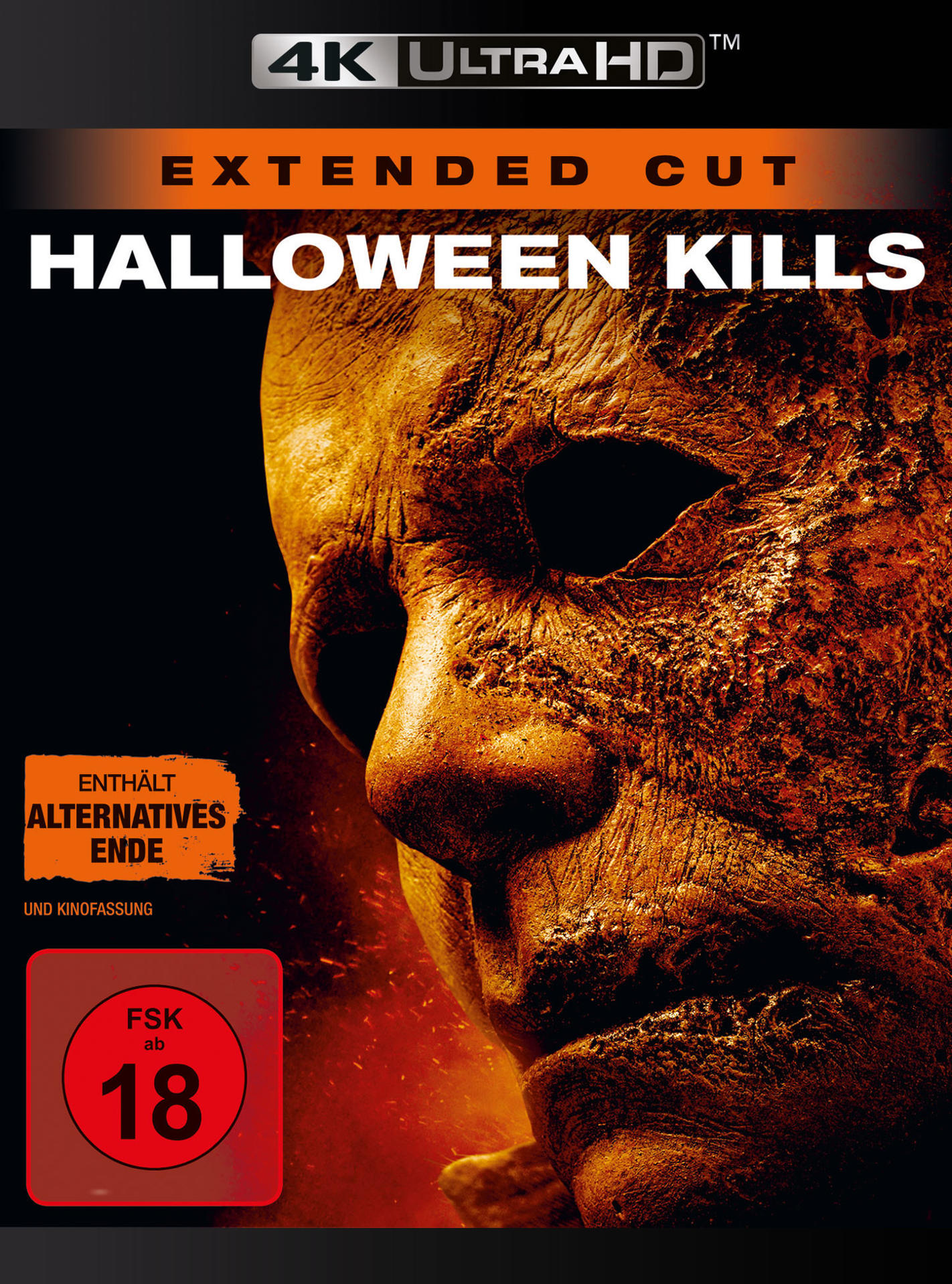 Filmplakat mit einem gruseligen Gesicht. Das Gesicht ist orange und gelb auf schwarzem Hintergrund.
