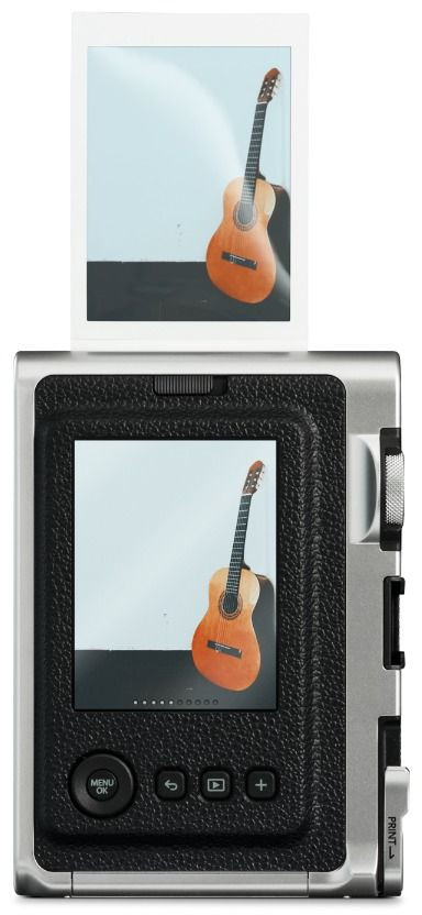 Polaroid photo of a guitar. Guitar leaning against a wall. Camera shows the same image.