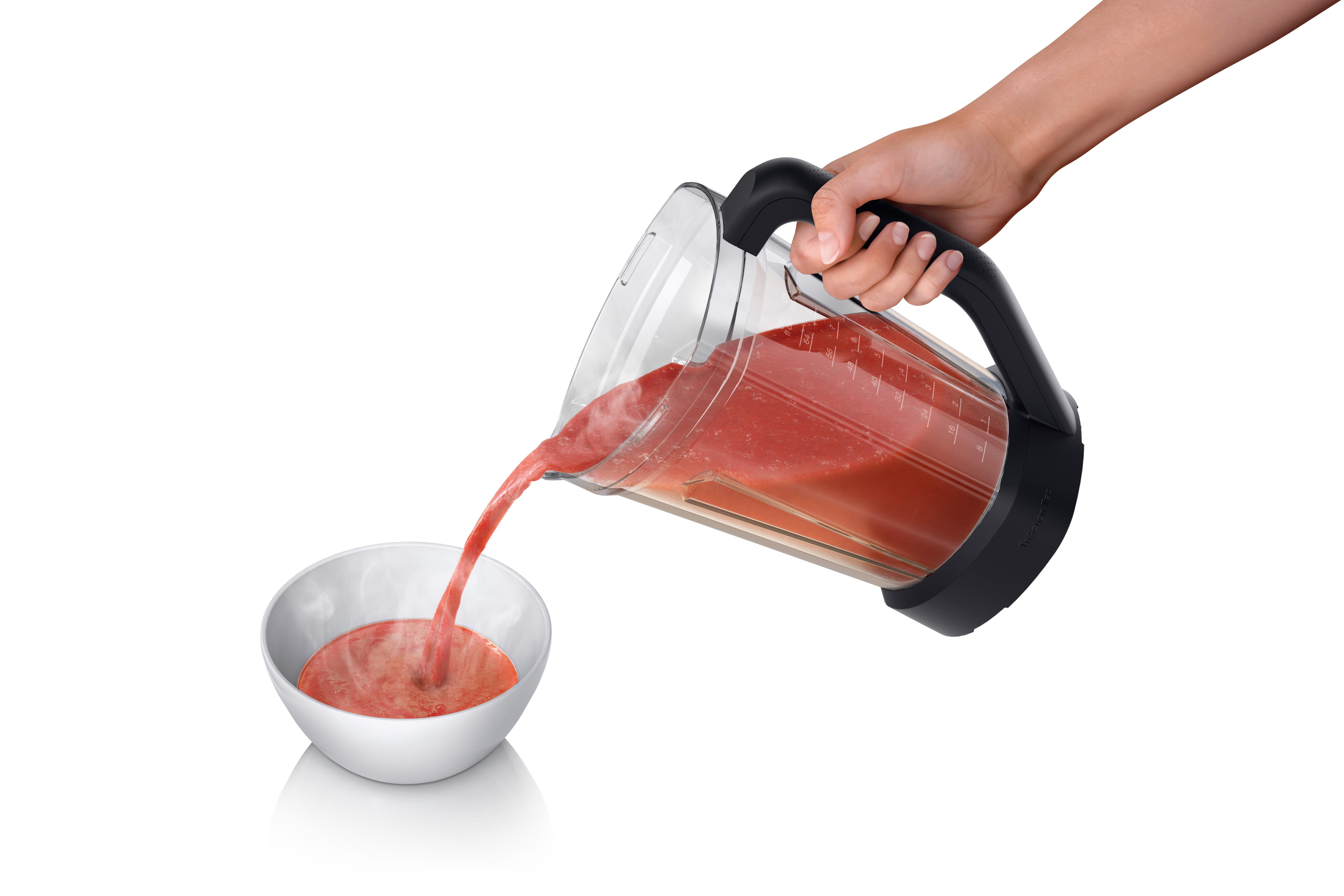 Eine Hand gießt rote Flüssigkeit aus einem Mixer in eine weiße Schüssel.