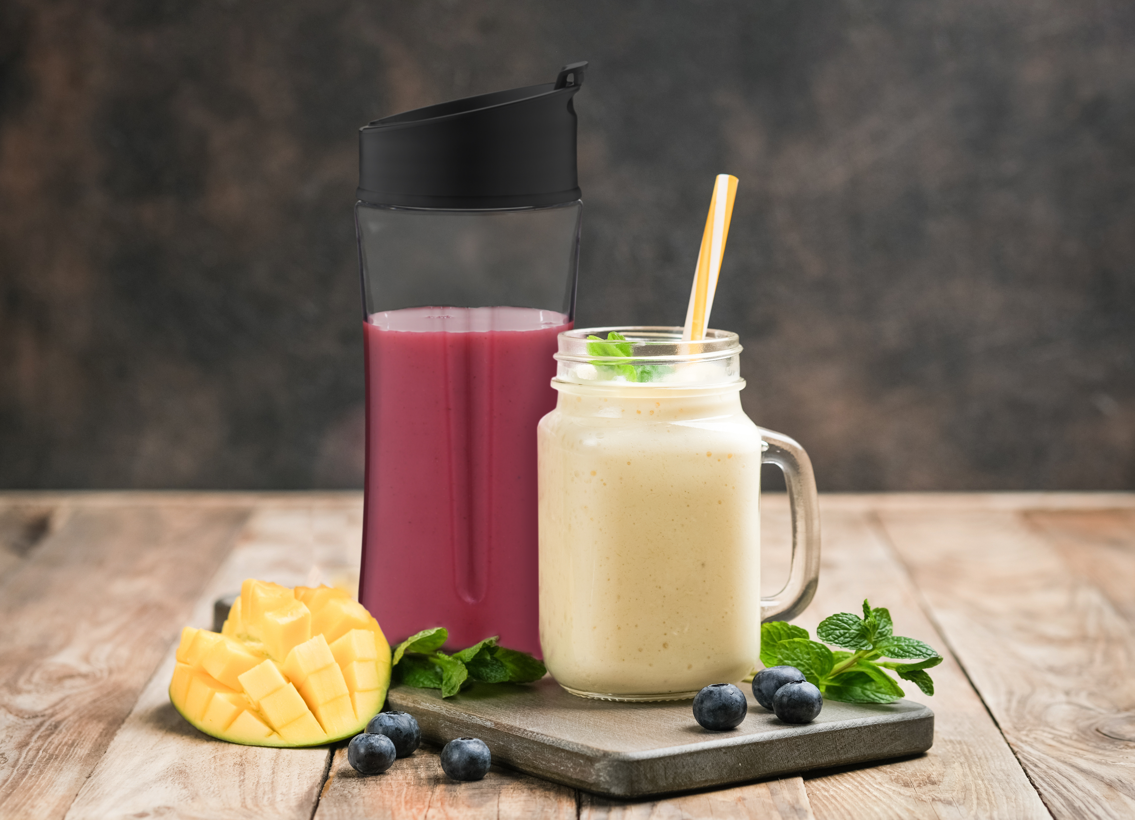 Smoothie und Saft in einem Glas und einer Flasche, mit Obst und Minze.