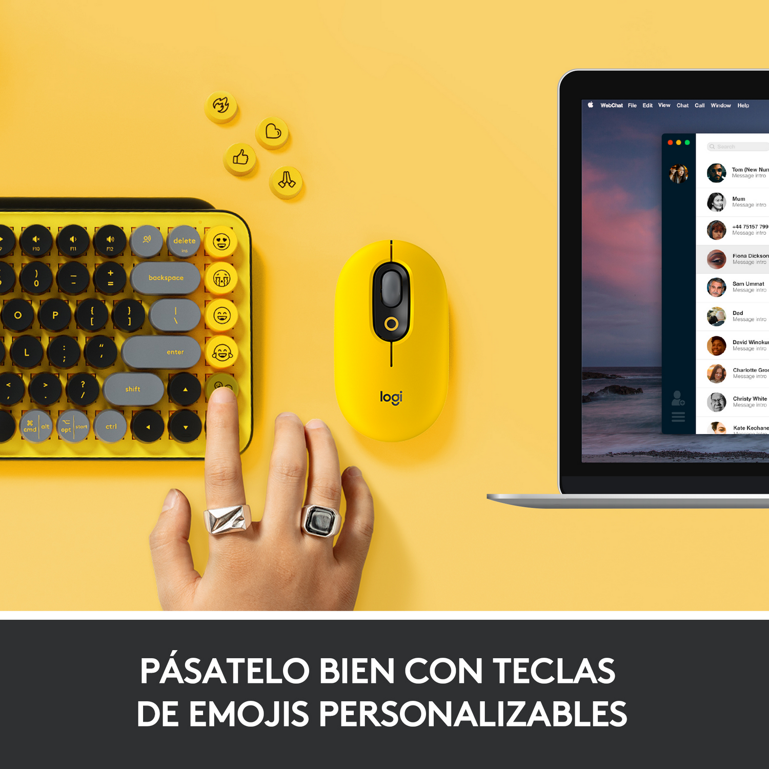 La mano de una persona usa un teclado amarillo y un ratón amarillo junto a una laptop.