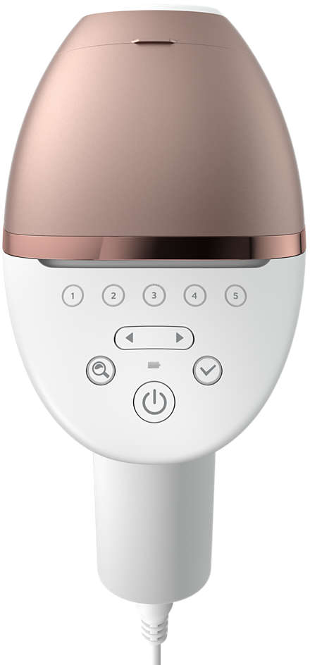 Appareil d'épilation blanc et or rose avec boutons et cordon d'alimentation.