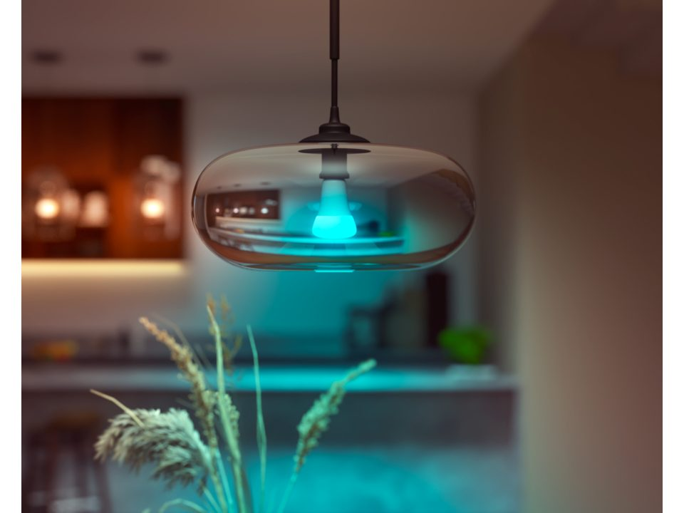 Un luminaire avec une ampoule éclairée en bleu dans un cadre domestique.